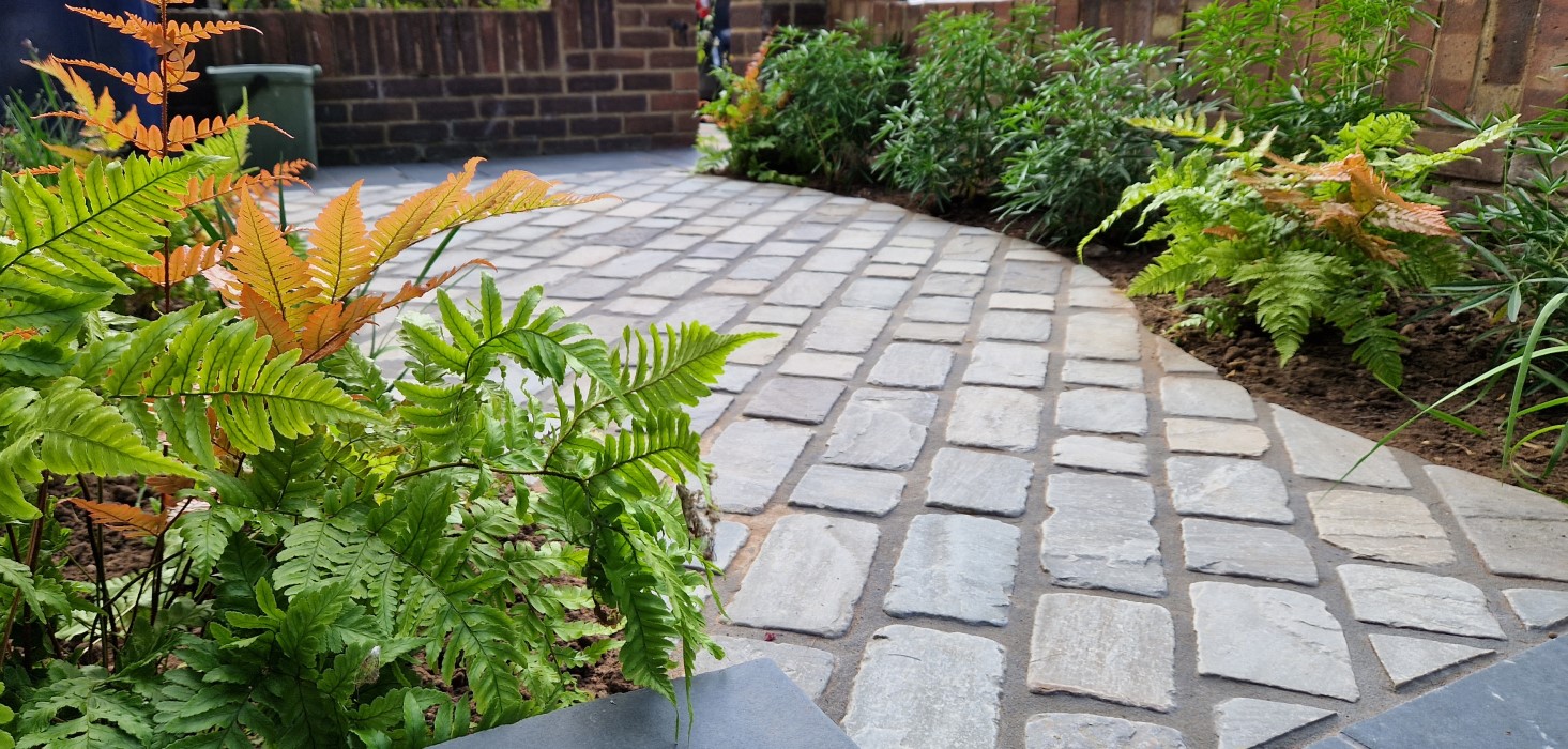 Small front garden with sandstone setts in Ealing